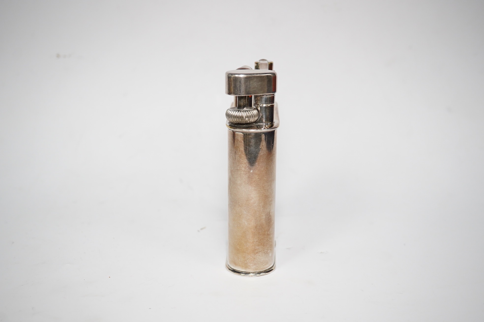 An engraved Alfred Dunhill plated table lighter, 10.7cm. Condition - fair, general wear to the plate